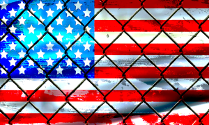 Image of US flag behind chain link fence