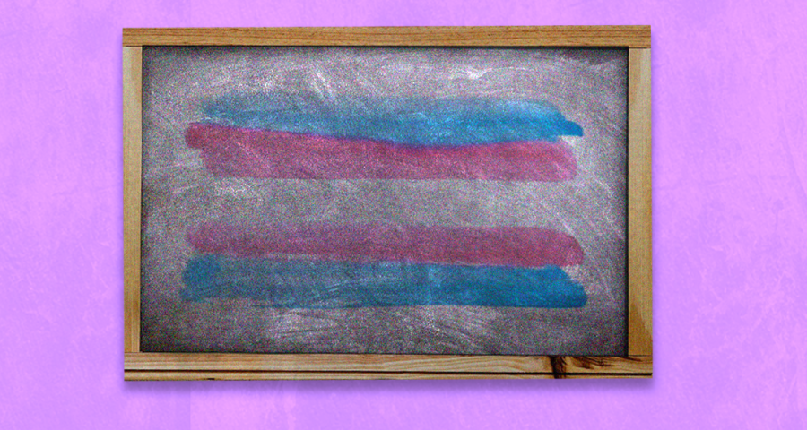 A trans flag on a chalkboard which has a lavender background.